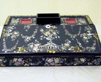 Lap Desk Wood, mother-of-pearl inlay, and red velvet lining. This lap desk was given to Charlotte Chandler Tenney by her students at Bradford Academy in 1835 in appreciation of her service.